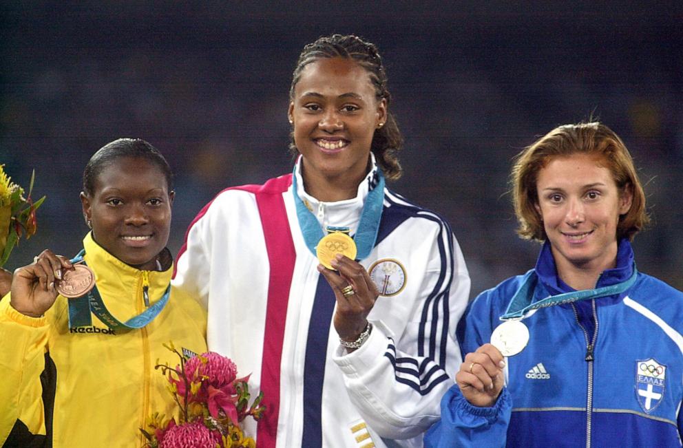 PHOTO: The winners of the women's 100m pose with their medals, Sept. 23, 2000, at the Sydney Olympic Games. Bronze winner Tanya Lawrence from Jamaica, gold medal winner Marion Jones from the US and silver medal winner Ekaterini Thanou from Greece. 