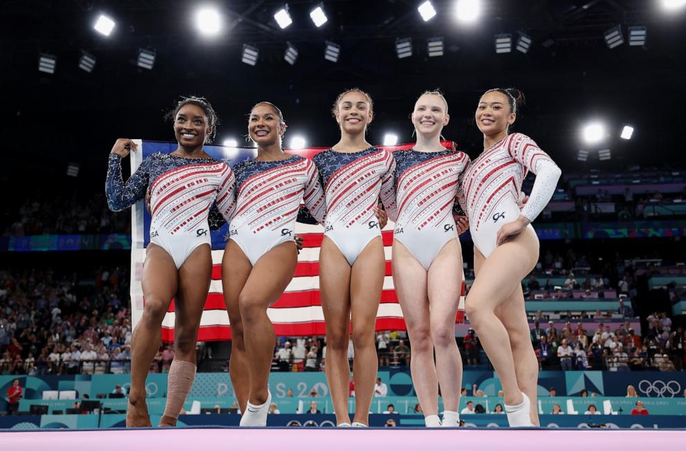 PHOTO: (L-R) Simone Biles, Jordan Chiles, Hezly Rivera, Jade Carey and Sunisa Lee of Team United States celebrate after winning the gold medal during the Artistic Gymnastics Women's Team Final at the 2024 Summer Olympic Games, July 30, 2024, in Paris.