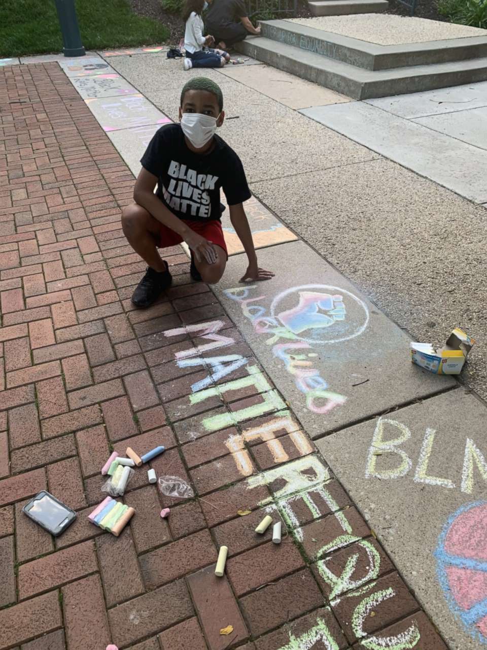 PHOTO: Josiah Wheeler, 11, draws art with chalk to support Black Lives Matter. 