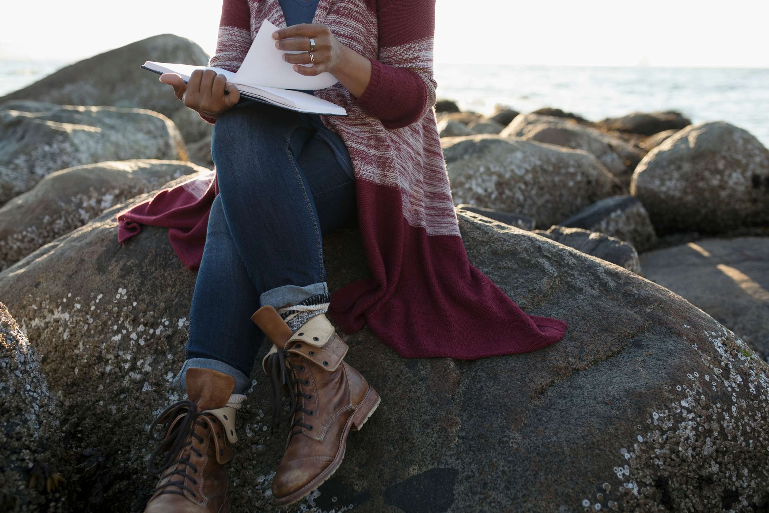 PHOTO: A woman sits on a rock.