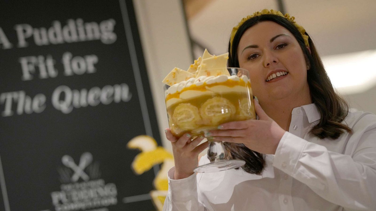 PHOTO: Jemma Melvin the Platinum Jubilee Pudding winner poses for the media with her creation, at a department store in London, May 13, 2022.