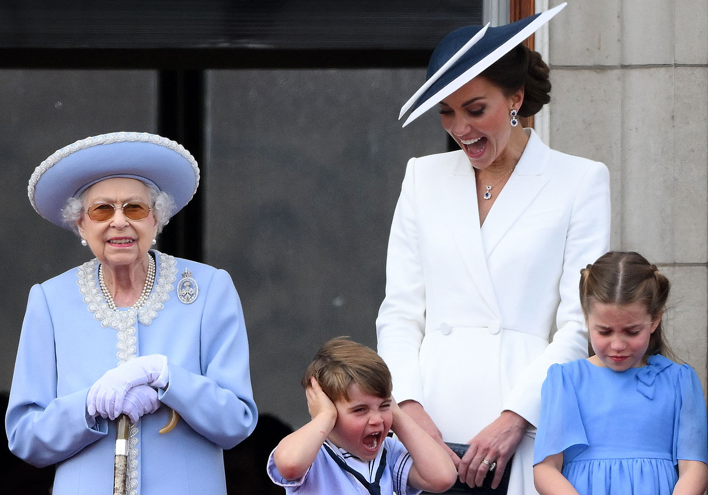 PHOTO: Catherine, Duchess of Cambridge, (2R) reacts as Britain's Prince Louis of Cambridge (2L) covers his ears, as they stand with Queen Elizabeth II (L), and  Princess Charlotte of Cambridge in London, June 2, 2022.