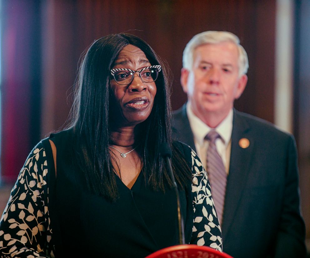PHOTO: Missouri Gov. Mike Parson looks on as the newest member of the Missouri Supreme Court, Judge Robin Ransom, addresses the media after being introduced by Parson during a press conference, May 24, 2021, at his Capitol office in Jefferson City, Mo.