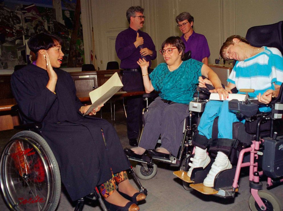 PHOTO: Judy Heumann, center wheelchair, is given an ovation at the swearing in as U.S. Assistant Secretary for Special Education and Rehabilitative Service in Berkeley, Calif., June 29, 1993. 
