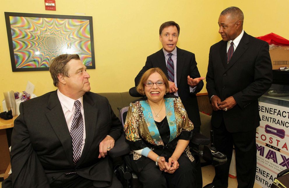 PHOTO:Actor John Goodman, left and Judy Heumann, Special Advisor for International Disability Rights at the U.S. Department of State, center, attend event at the Pageant Theater in St. Louis, April 28, 2012.