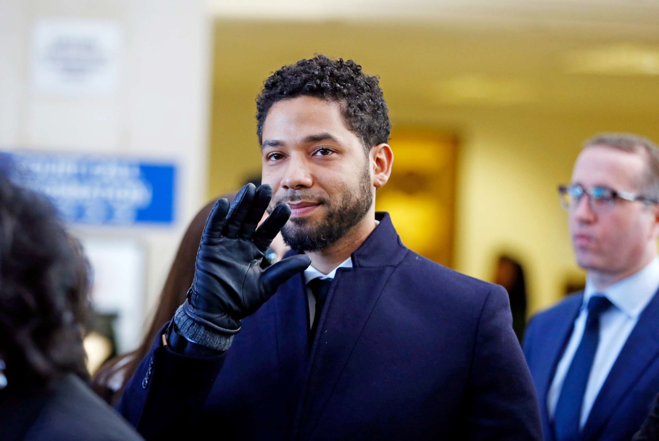 PHOTO: Jussie Smollett waves as he follows his attorney after his court appearance at Leighton Courthouse on March 26, 2019 in Chicago.