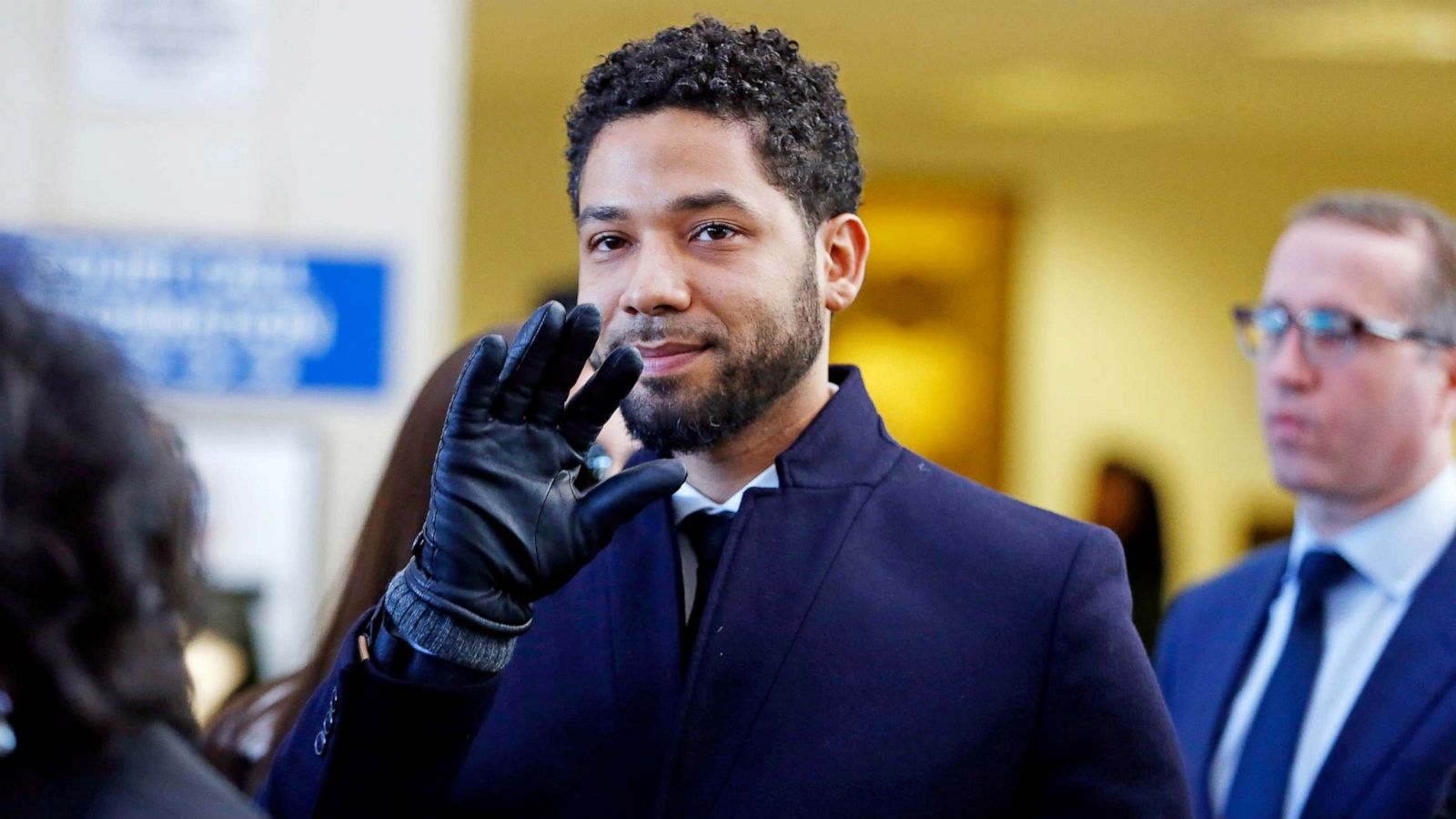 PHOTO: Jussie Smollett waves as he follows his attorney after his court appearance at Leighton Courthouse on March 26, 2019 in Chicago.