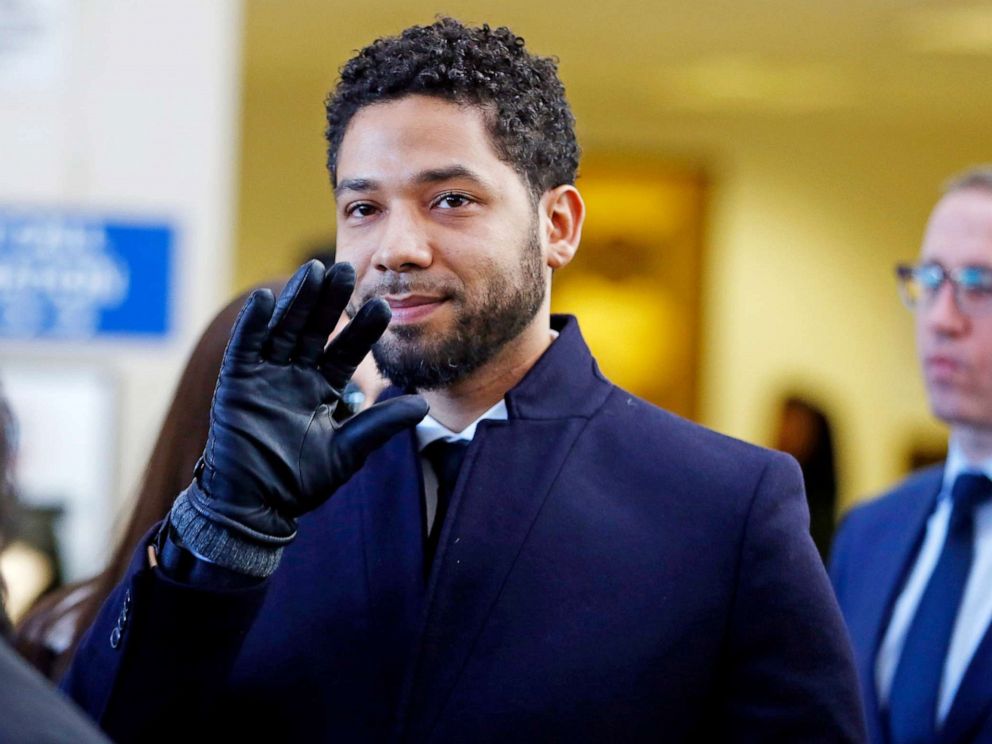 PHOTO: Jussie Smollett waves as he follows his attorney after his court appearance at Leighton Courthouse on March 26, 2019 in Chicago.