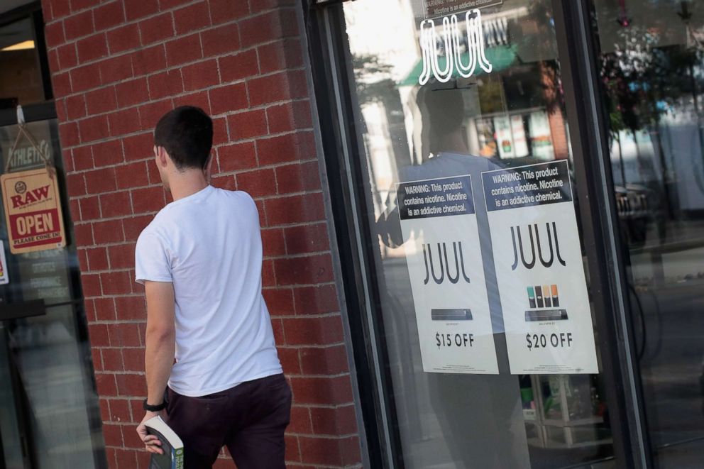 PHOTO: Signs in the window of the Smoke Depot advertise electronic cigarettes and pods by Juul, the nation's largest maker of e-cigarette products, on Sept. 13, 2018, in Chicago.