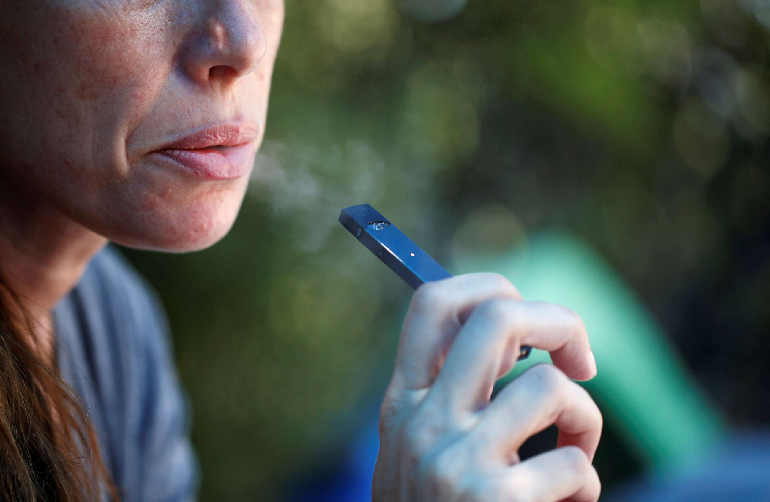 PHOTO: A woman smokes a Juul e-cigarette in this posed picture, Sept. 16, 2018.