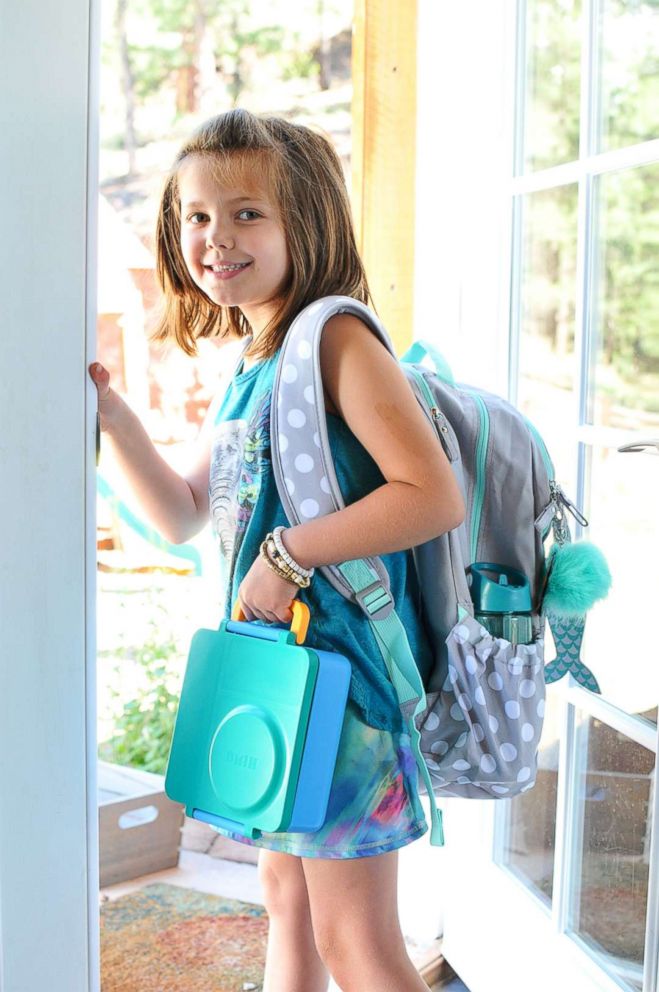 PHOTO: Kelly Pfeiffer's daughter Kaela, 8, poses before heading out to school holding a creative lunch made by her mom.