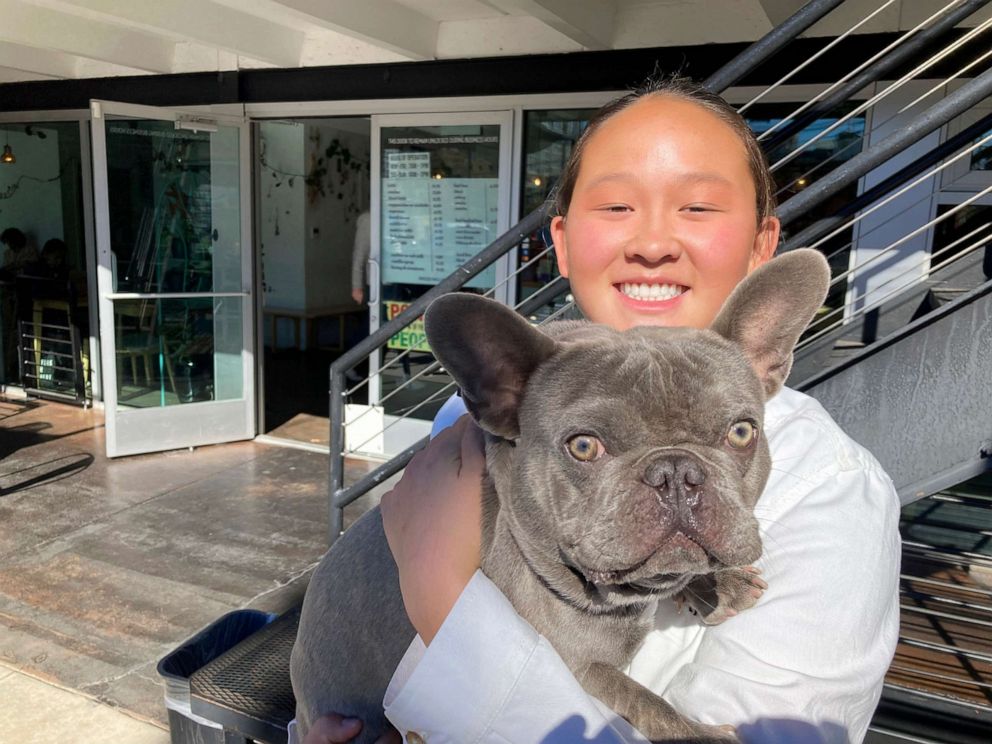 PHOTO: U.S. moguls skier Kai Owens poses with her French bulldog, Mochi, outside a coffee shop in Denver in this photo taken on Oct. 29, 2021.