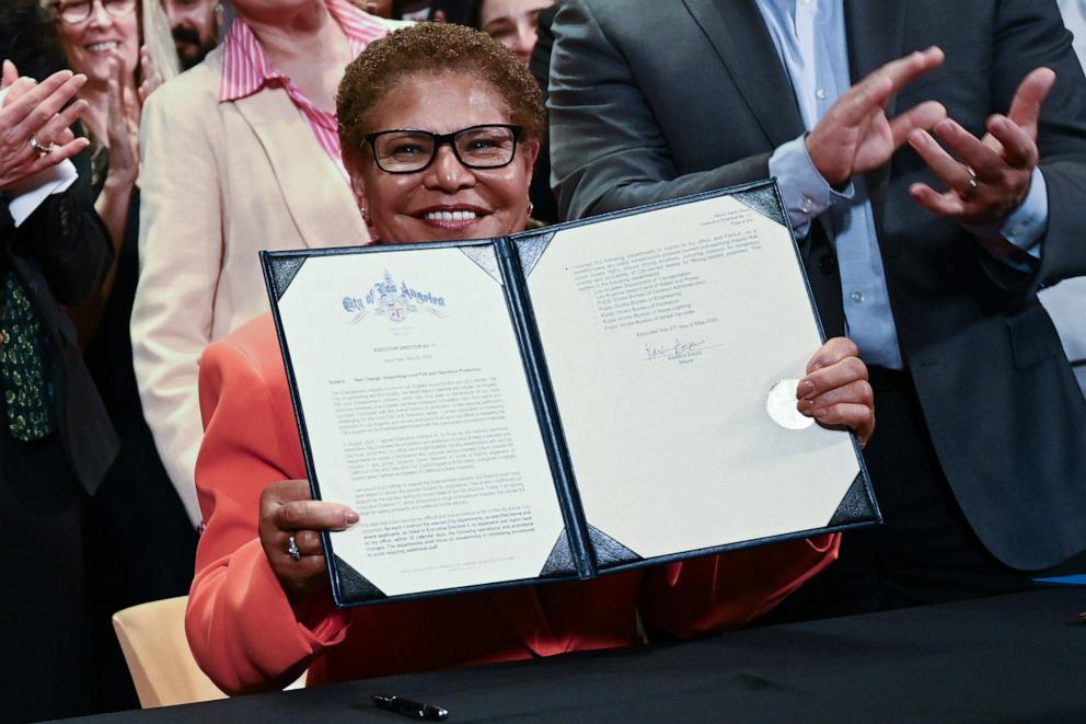PHOTO: Los Angeles Mayor Karen Bass holds up a signed executive directive announcing support for filming and production jobs, at the SAG-AFTRA Union headquarters in Los Angeles, on May 20, 2025. 