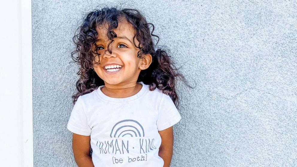 Portrait of Happy Smiling Little Girl in White T-shirt and Black