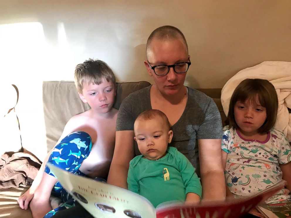 PHOTO: Kata Carter reads a book to her three children.