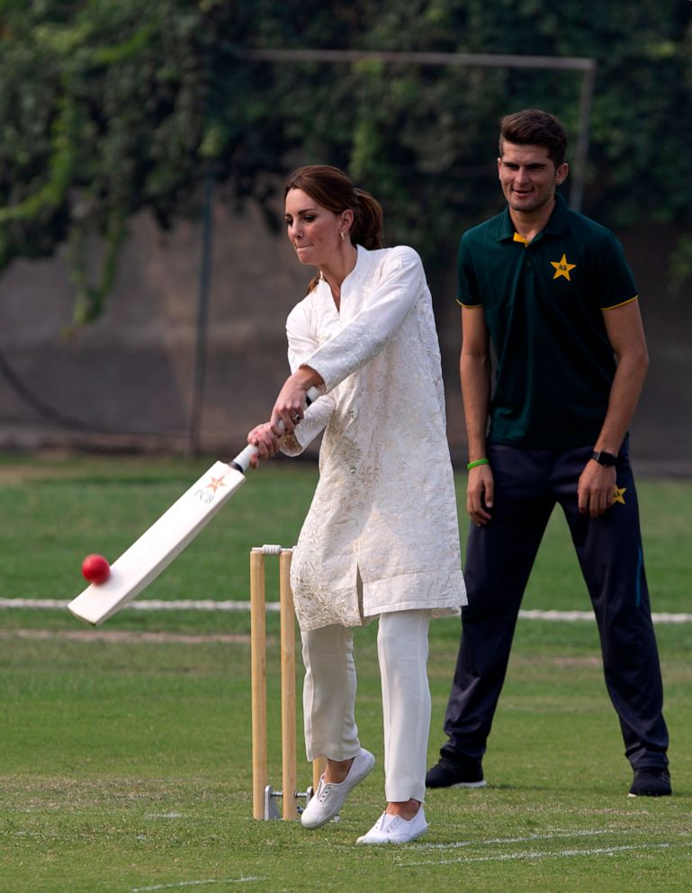 PHOTO: Catherine, Duchess of Cambridge, bats as Pakistani cricketer Shaheen Afridi looks on during her visit to the Pakistan Cricket Academy in Lahore, Pakistan, Oct. 17, 2019.