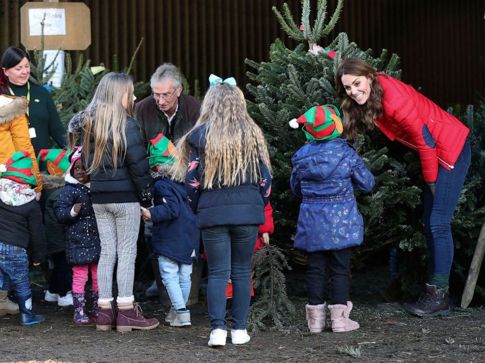 PHOTO: Children gather to help Britain's Kate the Duchess of Cambridge to pick a Christmas Tree, as she takes part in Christmas activities in Buckinghamshire, England, Dec. 4, 2019.