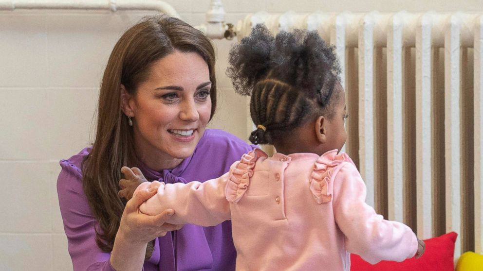 PHOTO: Britain's Kate the Duchess of Cambridge, reacts with a child, during a visit to the Henry Fawcett Children's Centre in Kennington, London, March 12, 2019.