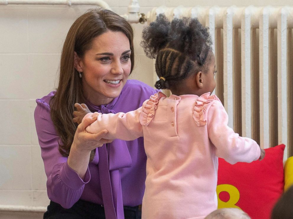 PHOTO: Britain's Kate the Duchess of Cambridge, reacts with a child, during a visit to the Henry Fawcett Children's Centre in Kennington, London, March 12, 2019.