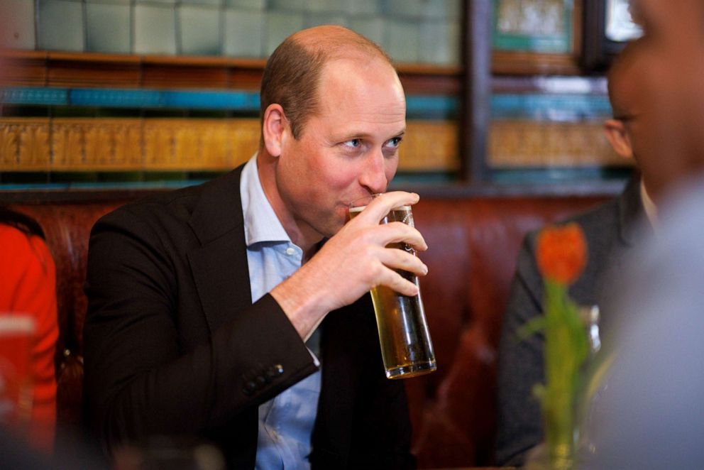 PHOTO: Britain's Prince William drinks a pint of cider, as he and Kate, Princess of Wales visit the Dog & Duck pub in London, May 4, 2023.