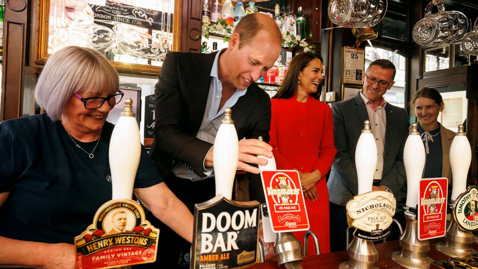 PHOTO: Prince William, Prince of Wales pulls the first pint of Kingmaker a new brew celebrating the coronation as Catherine, Princess of Wales looks on at the Dog and Duck pub in Soho ahead of this weekend's coronation on May 4, 2023 in London.