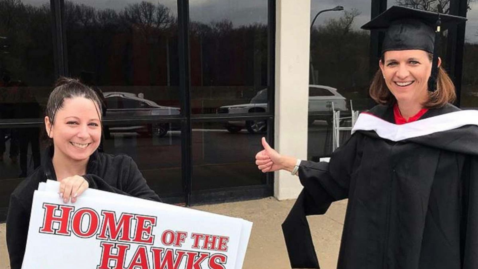 PHOTO: Teacher, Kathleen Durkin, delivered yard signs to high school seniors while dressed in a cap and gown on April 24, 2020 in Park Ridge, Illinois.