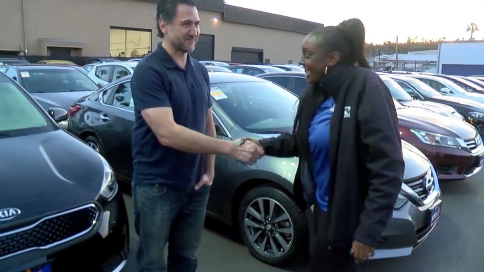 PHOTO: Kayla Cooper, 22, of San Diego, California, shakes hands with Dan Laguardia, 49, after he gave her his 2005 Scion instead of trading it in.