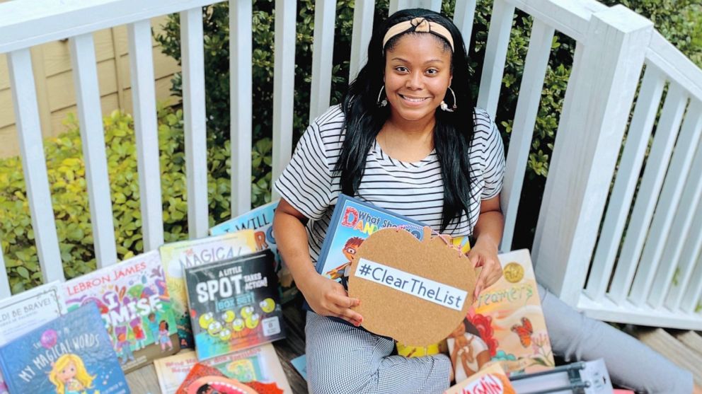 PHOTO: Kayla Richardson, a 4th grade ESL teacher in Texas, poses with children's books she received from Chrissy Teigen.