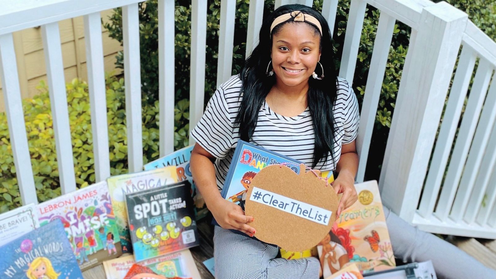 PHOTO: Kayla Richardson, a 4th grade ESL teacher in Texas, poses with children's books she received from Chrissy Teigen.