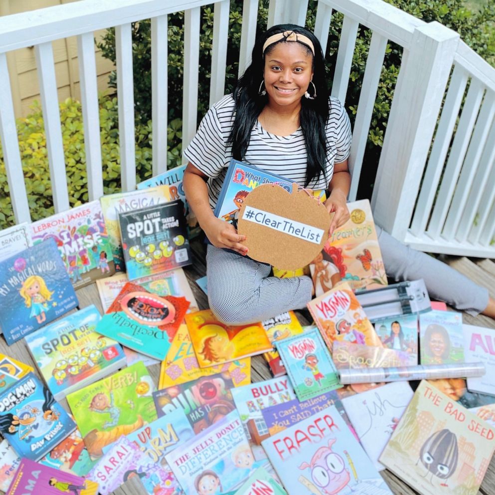 PHOTO: Kayla Richardson, a 4th grade ESL teacher in Texas, poses with children's books she received from Chrissy Teigen.