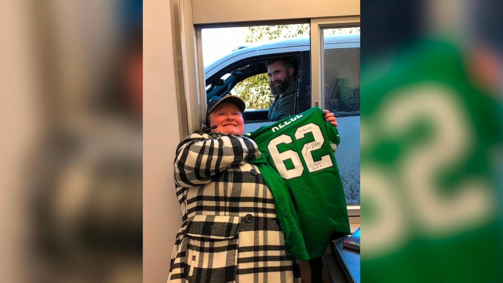 PHOTO: Jason Kelce signs a jersey for McDonalds employee, Danielle Bonham.