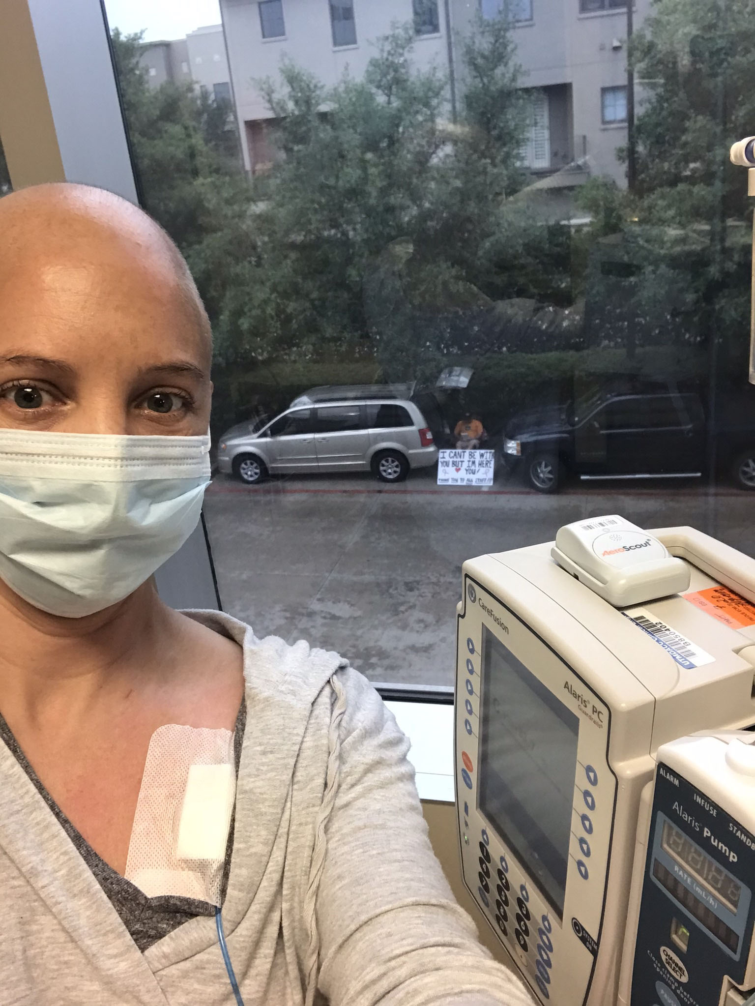 PHOTO: Kelly Conner takes a selfie with her husband Albert Conner in the background at the University of Texas MD Anderson Cancer Center in Sugar Land, Texas.