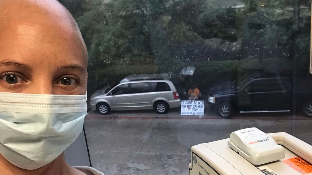 PHOTO: Kelly Conner takes a selfie with her husband Albert Conner in the background at the University of Texas MD Anderson Cancer Center in Sugar Land, Texas.