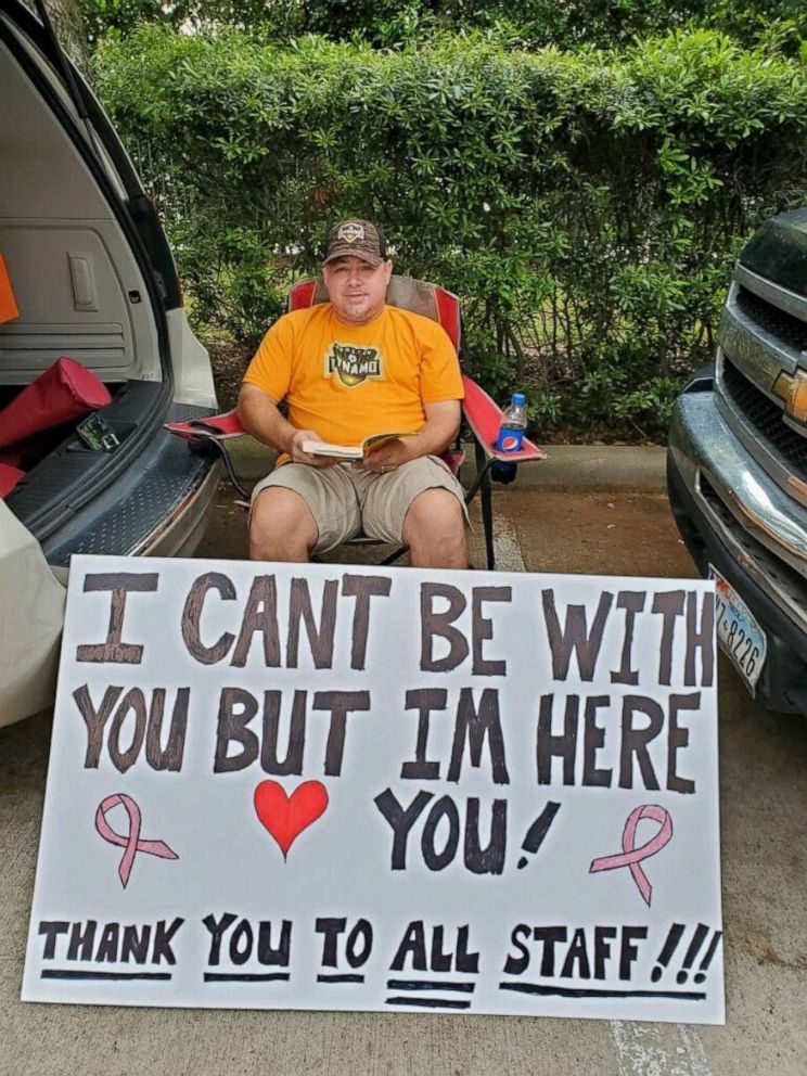 PHOTO: Albert Conner held a sign for his wife as she received chemotherapy at the University of Texas MD Anderson Cancer Center in Sugar Land, Texas.