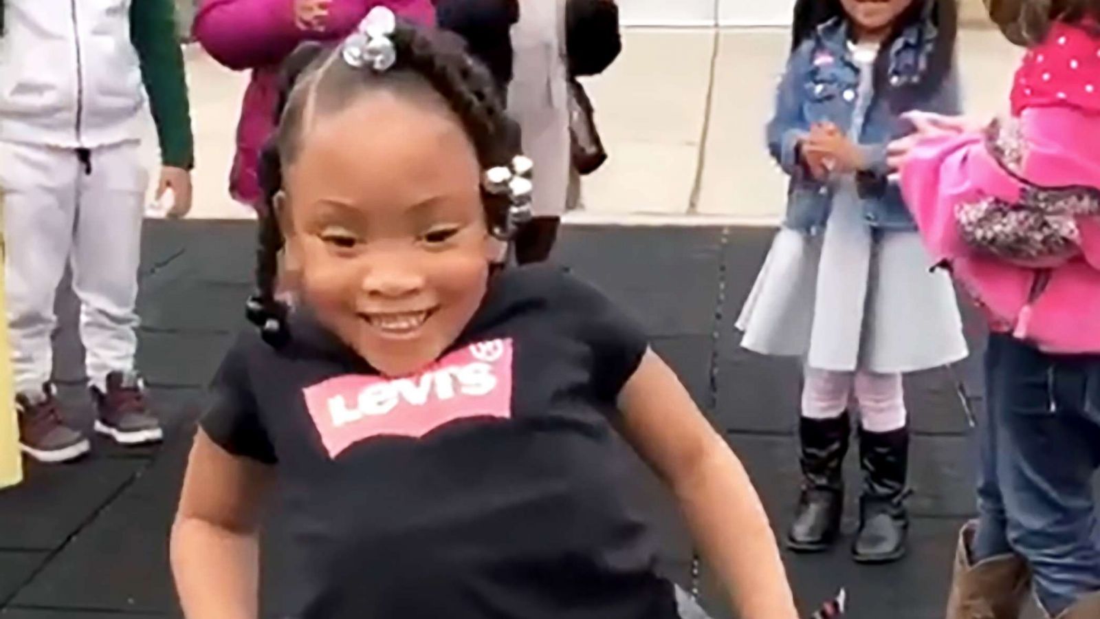 PHOTO: 4-year-old Kenydii takes her first steps on her own as her classmates cheer her on.