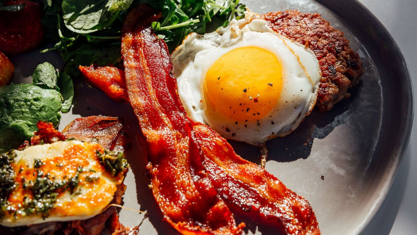 PHOTO: A Keto diet breakfast consisting of fried egg, bacon, cheese, ground beef and salad.