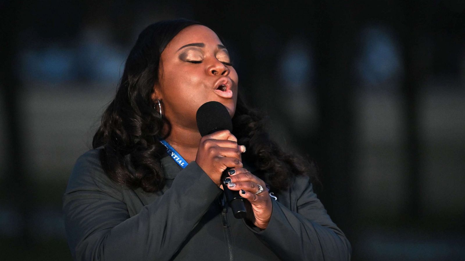 PHOTO: Michigan nurse Lori Marie Key of Saint Joseph Mercy Health System sings "Amazing Grace" during a COVID-19 memorial service at the Lincoln Memorial in Washington, D.C., Jan. 19, 2021, to honor the lives of those lost to pandemic.