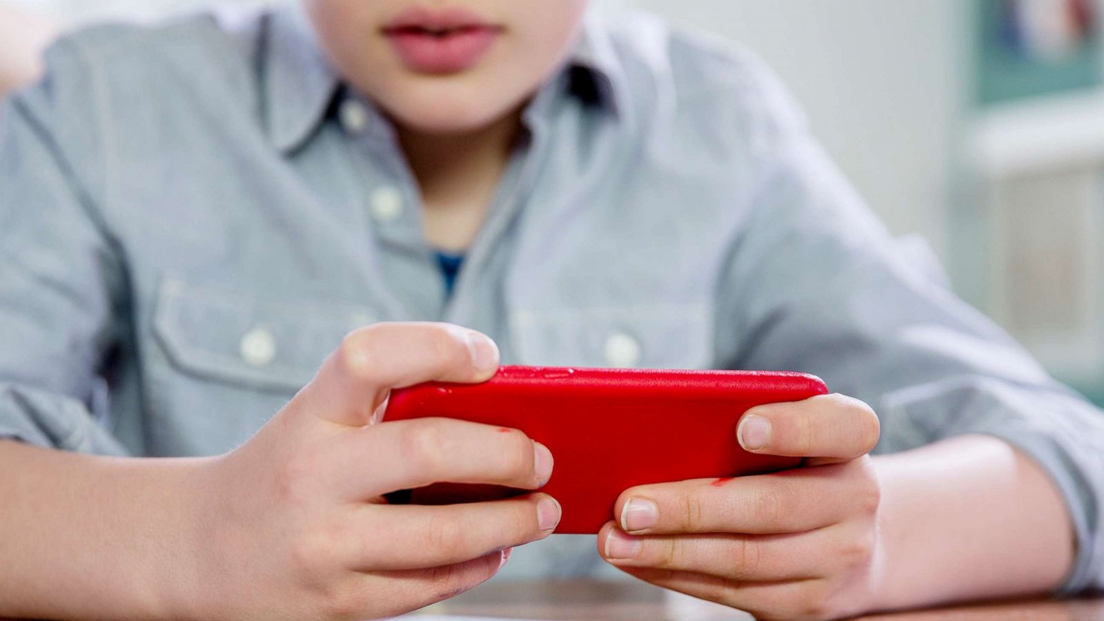 PHOTO: A boy uses a hand-held device in this undated stock photo.