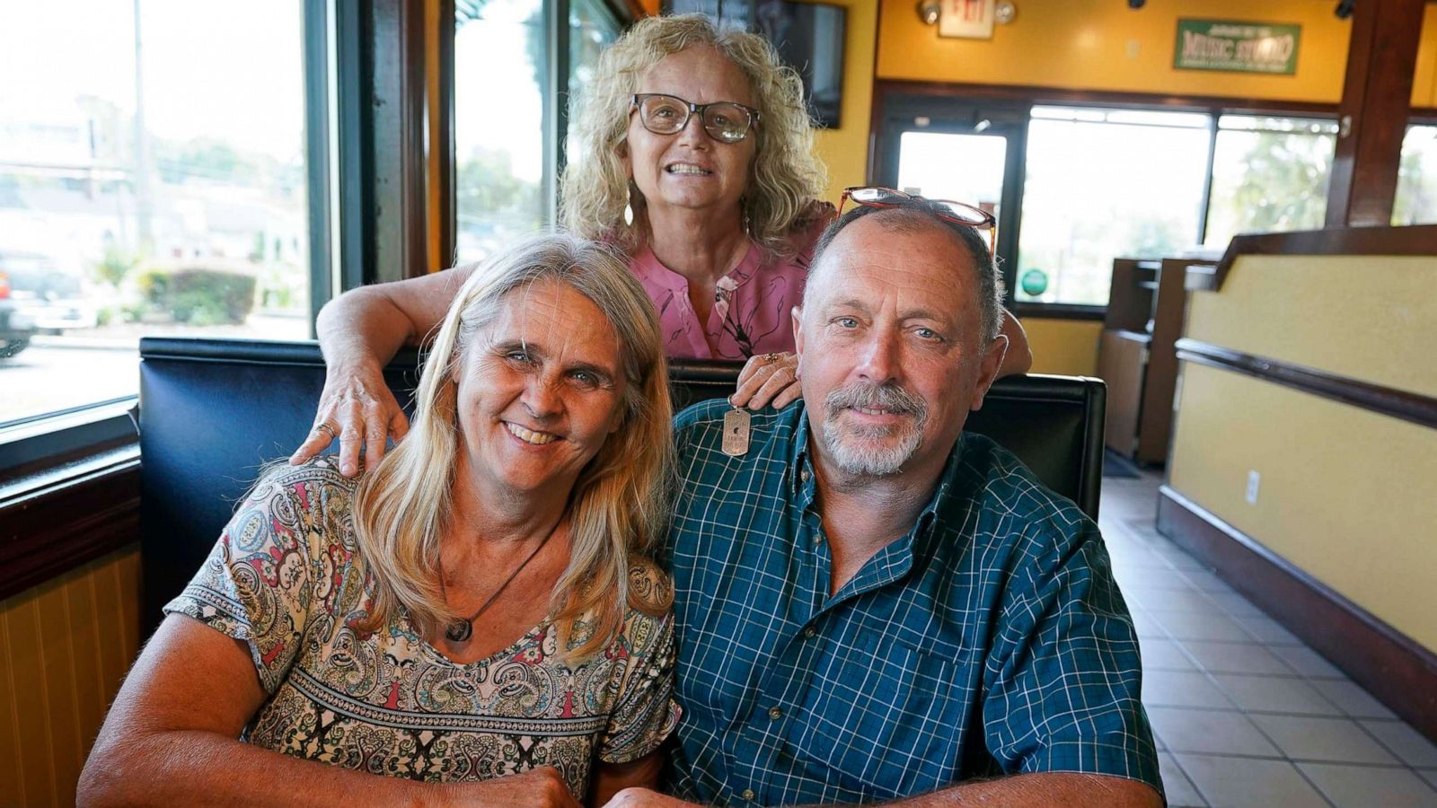 PHOTO: Two days after Debby-Neal Strickland, front left, and Jim Merthe were married in November, Debby donated a kidney to James' ex-wife Mylaen Merthe, center back, as the three get together, May 25, 2021, at a restaurant in Ocala, Fla.