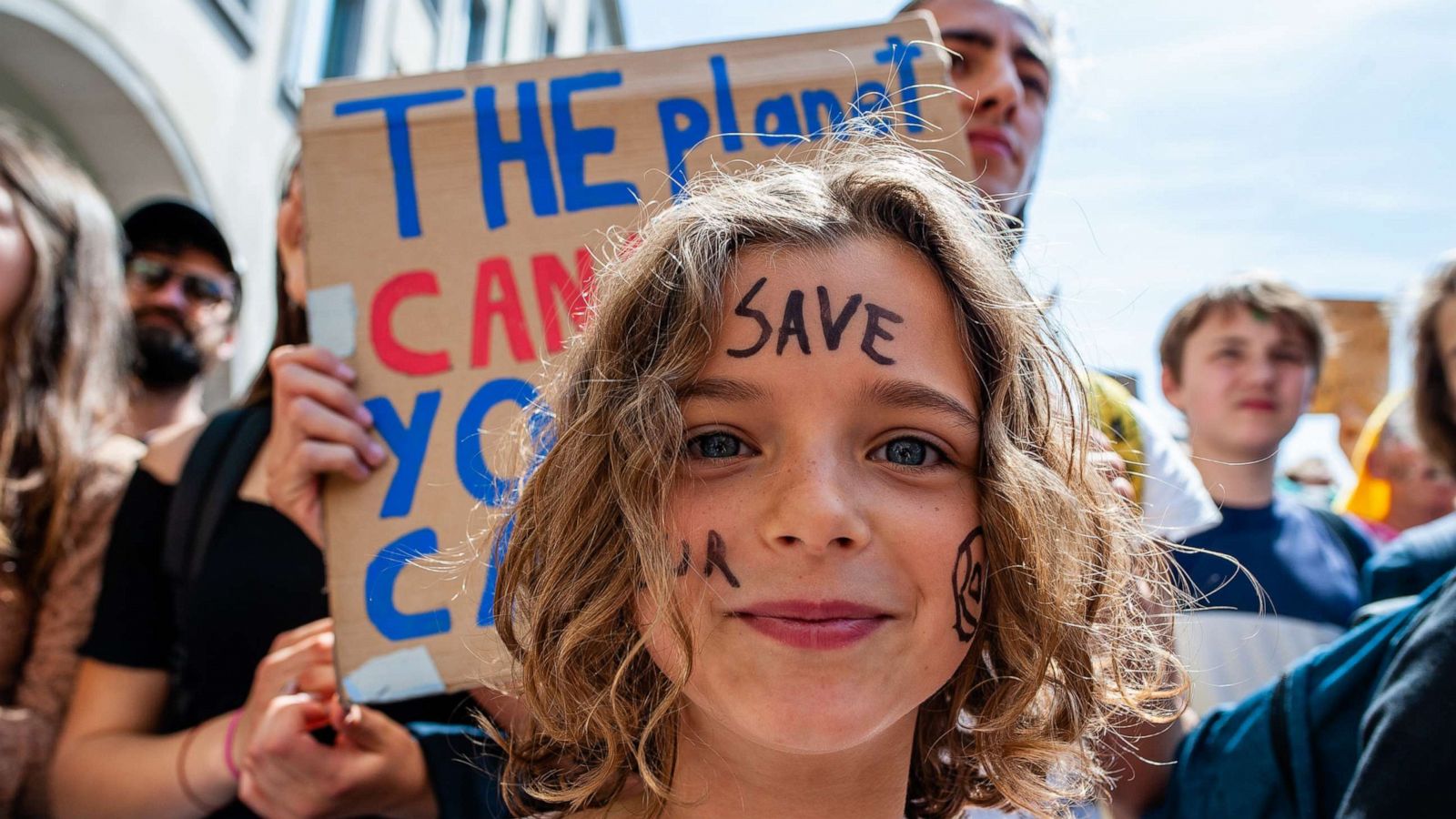 PHOTO: A little girl is seen'Save our planet' written on her face a climate protest in Brussels, May 24, 2019.