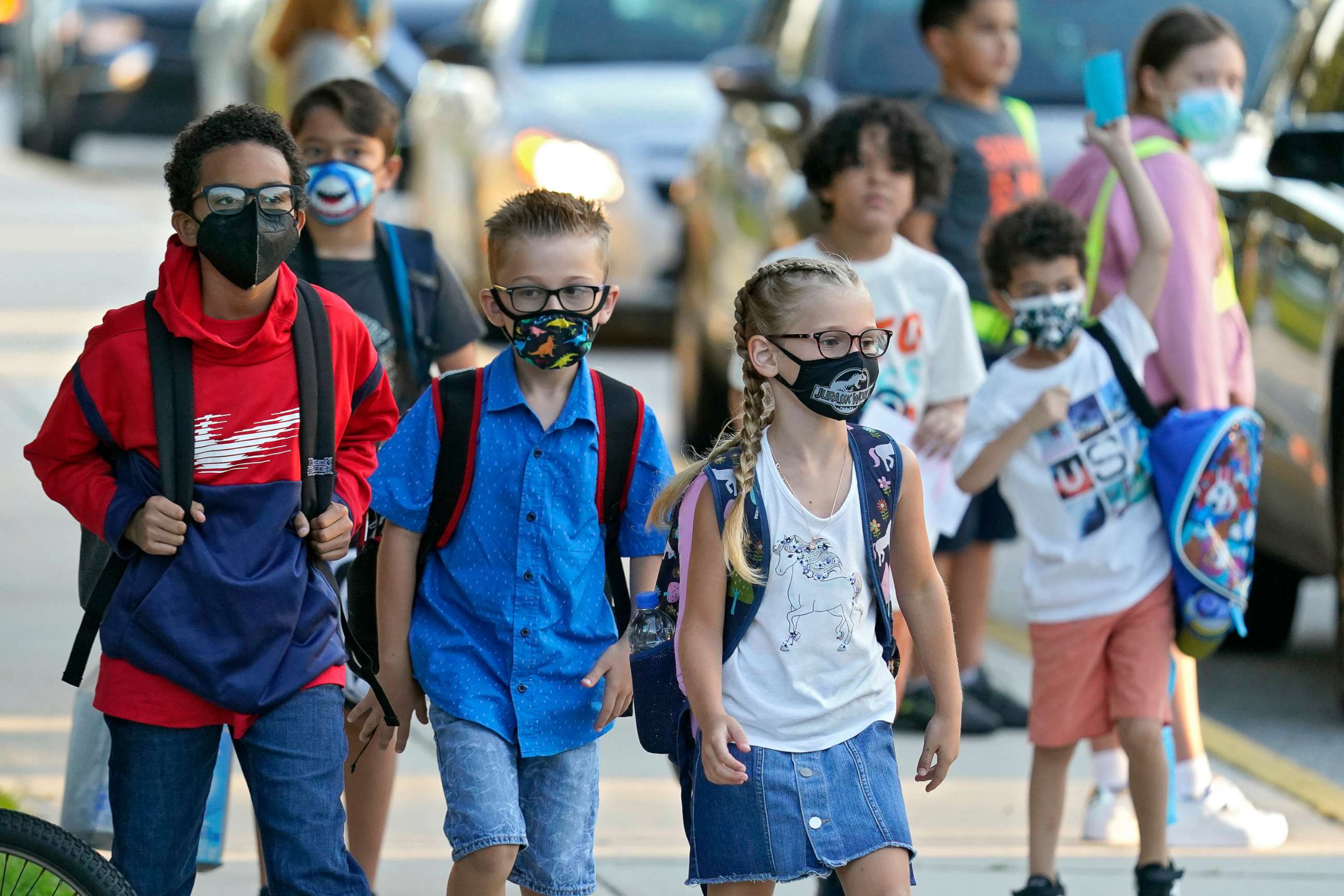 PHOTO: Students, some wearing protective masks, arrive for the first day of school at Sessums Elementary School, Aug. 10, 2021, in Riverview, Fla. Students are required to wear the masks in class unless their parents opt out.