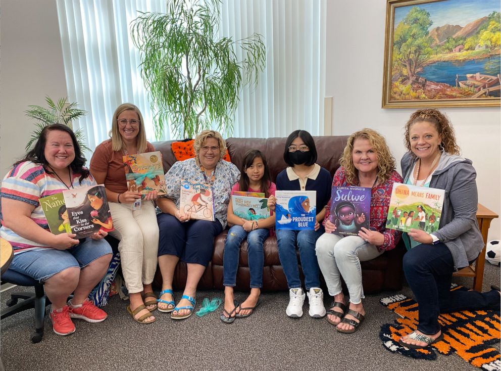 PHOTO: Emi Kim, 9, delivering some of the books she purchased to local Utah school administration and faculty.