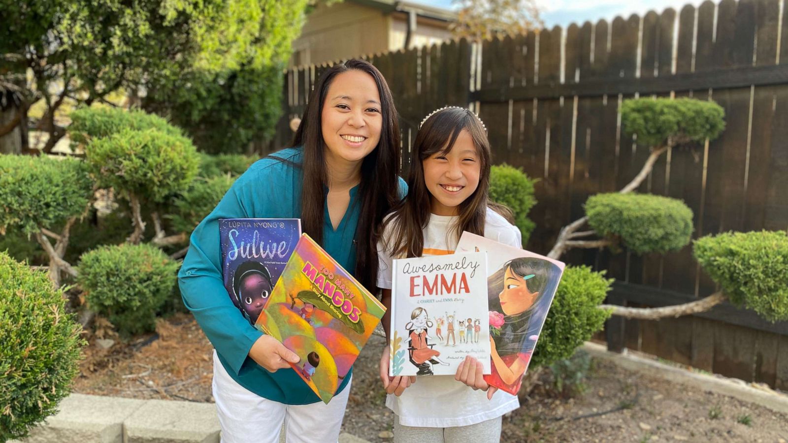 PHOTO: Emi, 9, and Dorie, 36, Kim with some of the diverse books they bought with the funds from the lemonade stand.