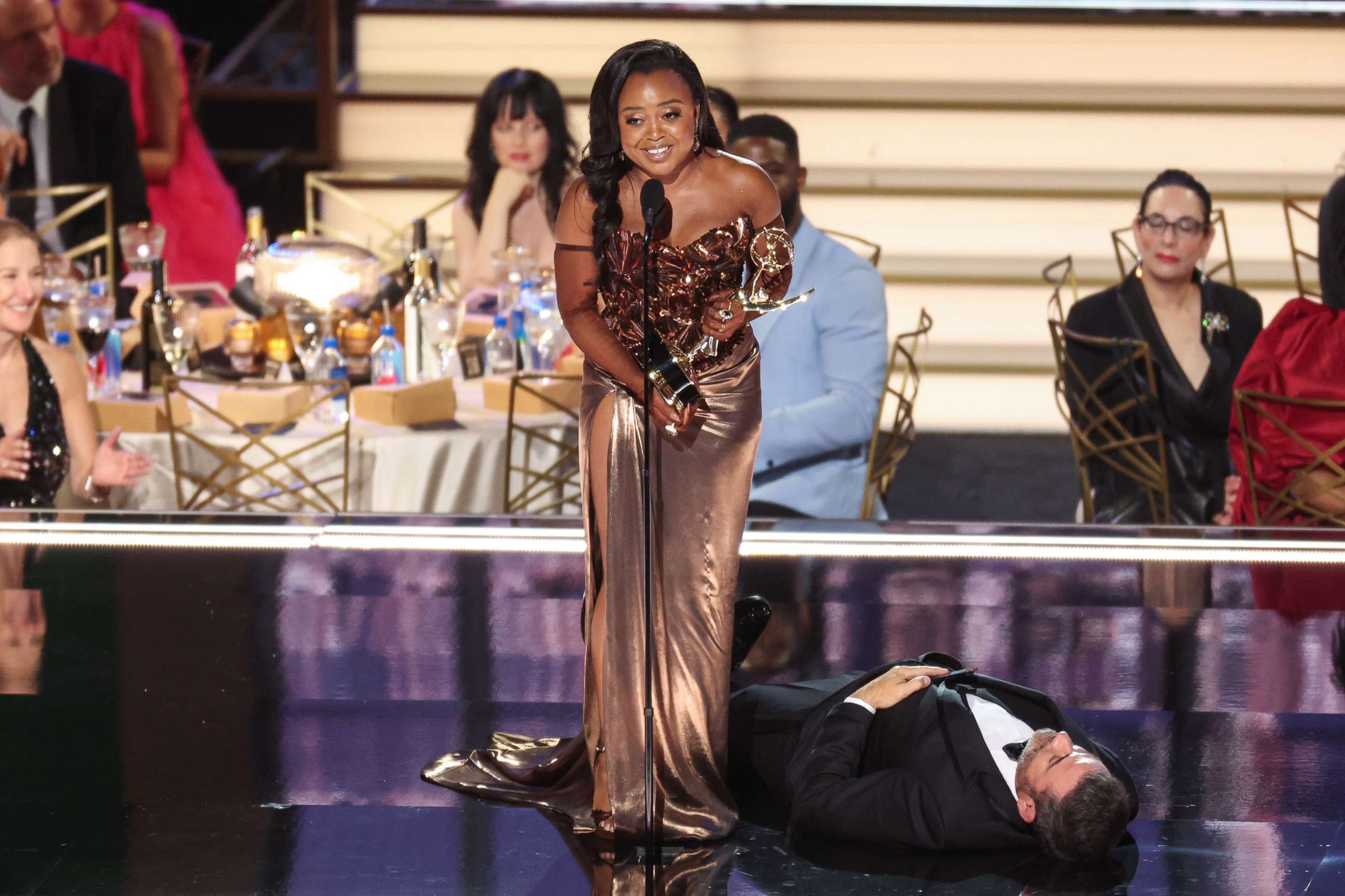 PHOTO: Television host Jimmy Kimmel lies onstage as writer Quinta Brunson accepts the award for outstanding writing for a comedy series for "Abbott Elementary" during the 74th Emmy Awards in Los Angeles, Sept. 12, 2022.