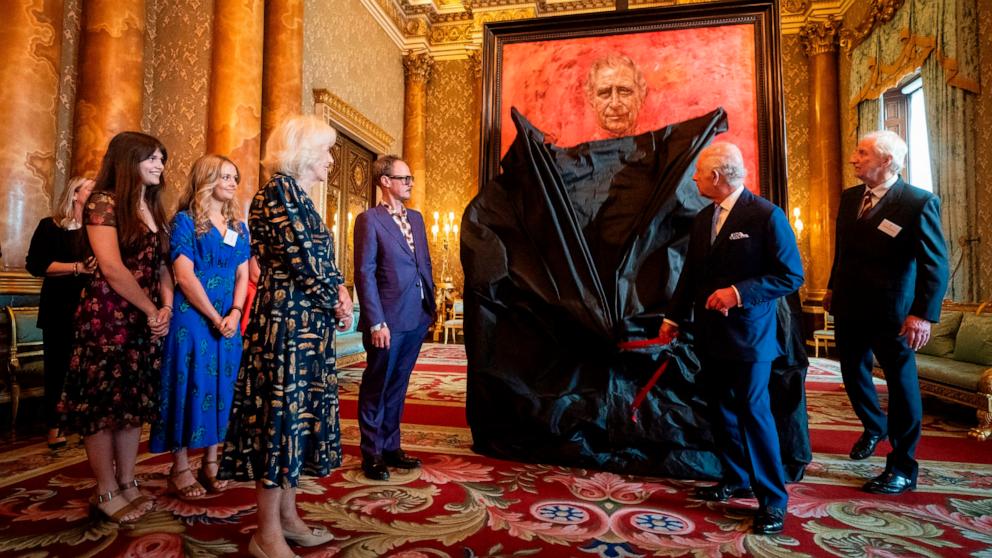 PHOTO: Britain's King Charles III and Queen Camilla at the unveiling of artist Jonathan Yeo's portrait of the King, in the blue drawing room at Buckingham Palace, in London, May 14, 2024.