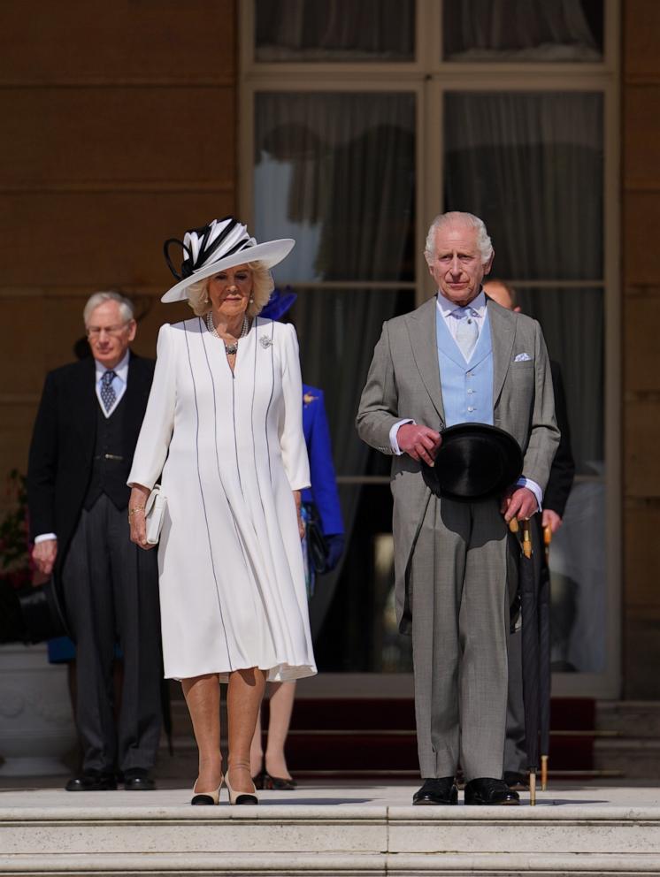 PHOTO: Britain's King Charles III, right, and Queen Camilla listen to the National Anthem during a Royal Garden Party at Buckingham Palace, May 8, 2024, in London.