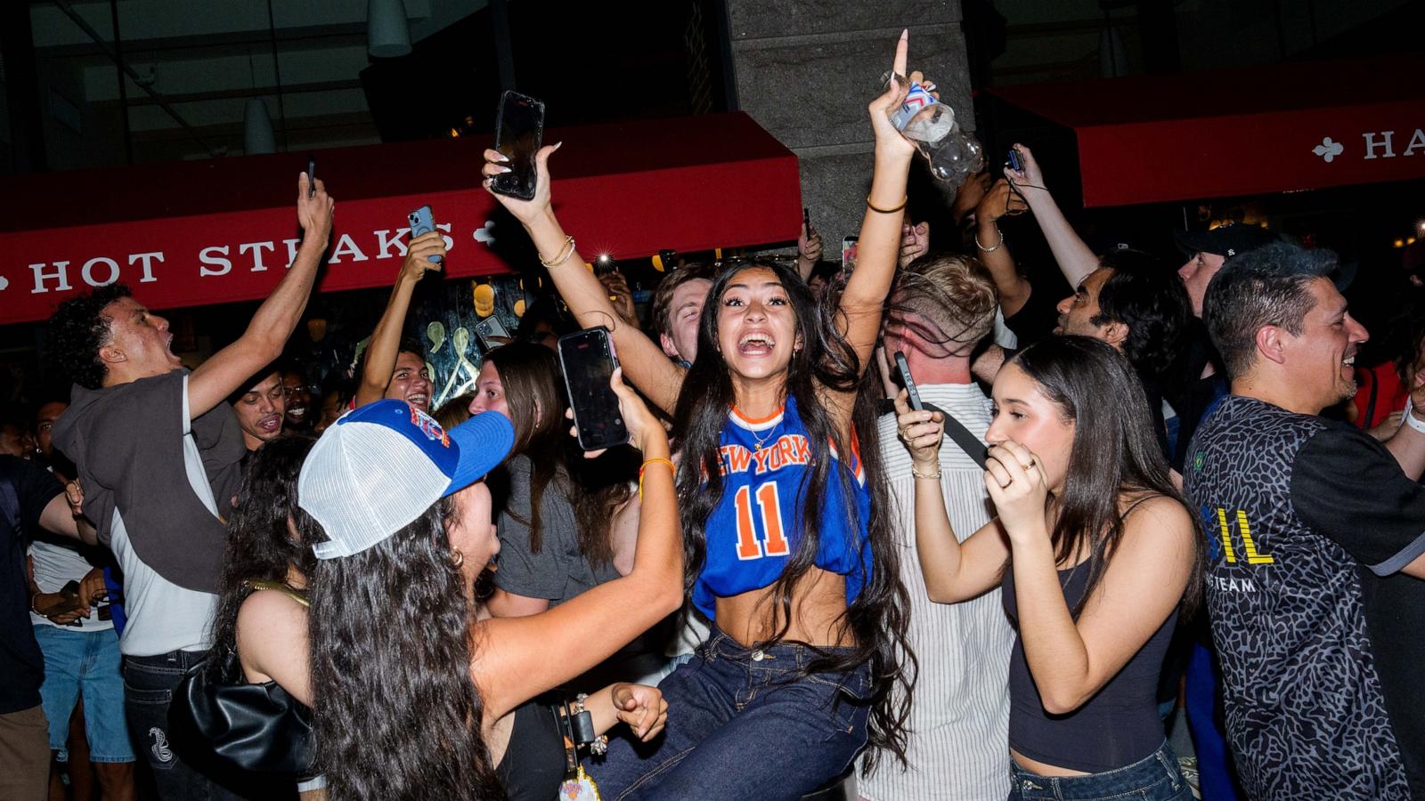 PHOTO: New York Knicks fans celebrate as they win against San Antonio Spurs in Game 5 of the NBA Finals, June 13, 2026, in New York.