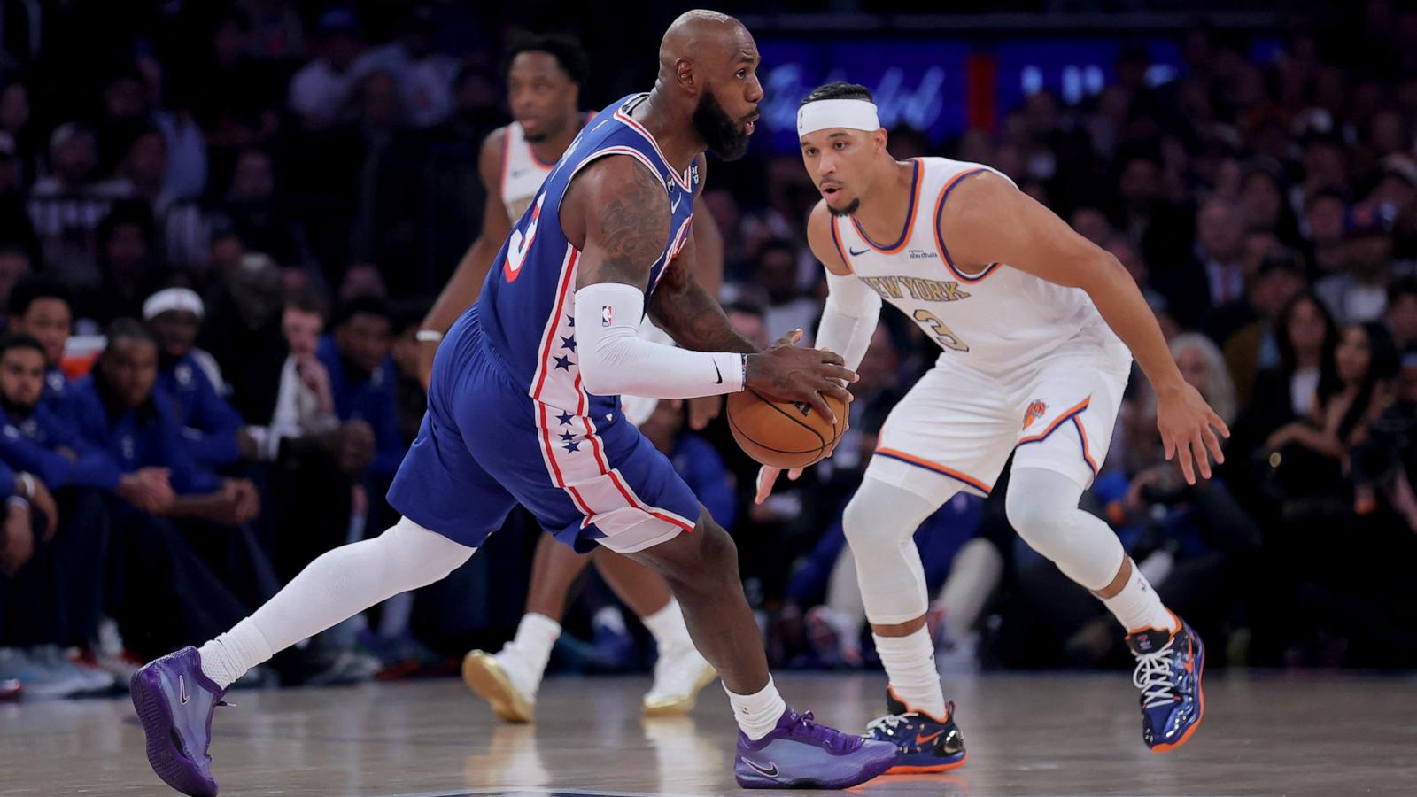 PHOTO: Philadelphia 76ers forward LeBron James looks to pass the ball against New York Knicks guard Josh Hart during the first quarter of their game, Oct 20, 2026, in New York City.