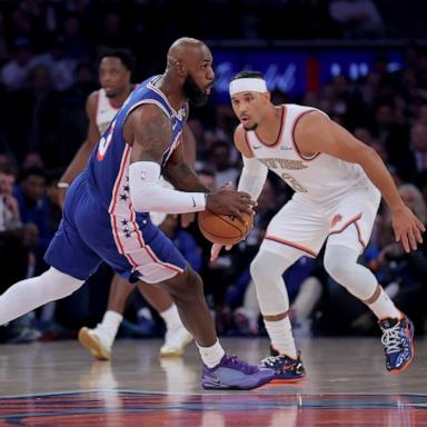 PHOTO: Philadelphia 76ers forward LeBron James looks to pass the ball against New York Knicks guard Josh Hart during the first quarter of their game, Oct 20, 2026, in New York City.