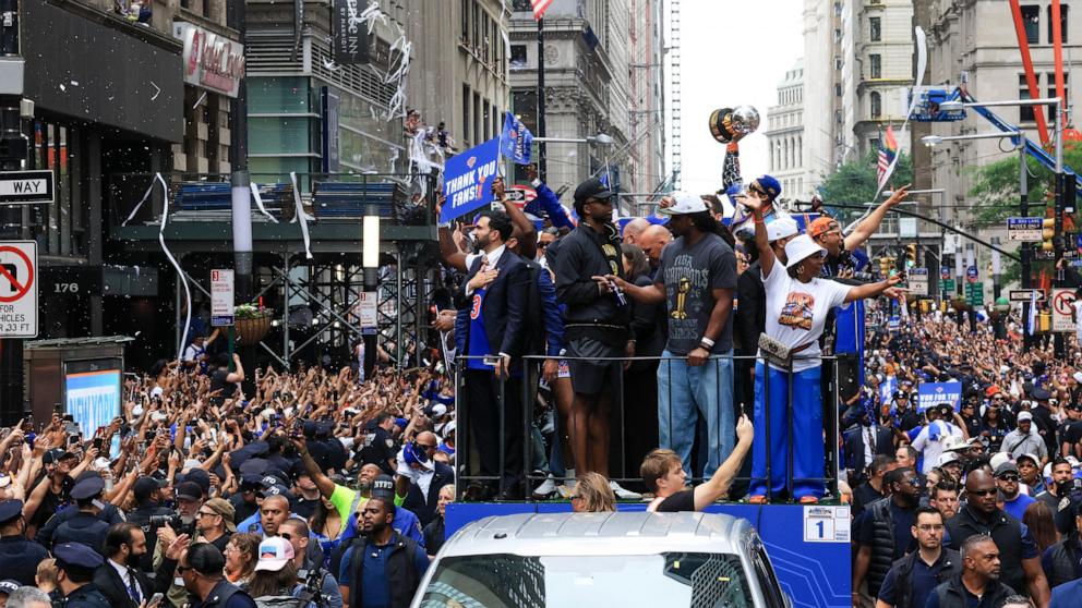 PHOTO: Members of the New York Knicks joined by New York City Mayor Zohran Mamdani ride atop an open-top bus during a championship ticker-tape parade celebrating the team's NBA Finals victory in New York, on June 18, 2026. 